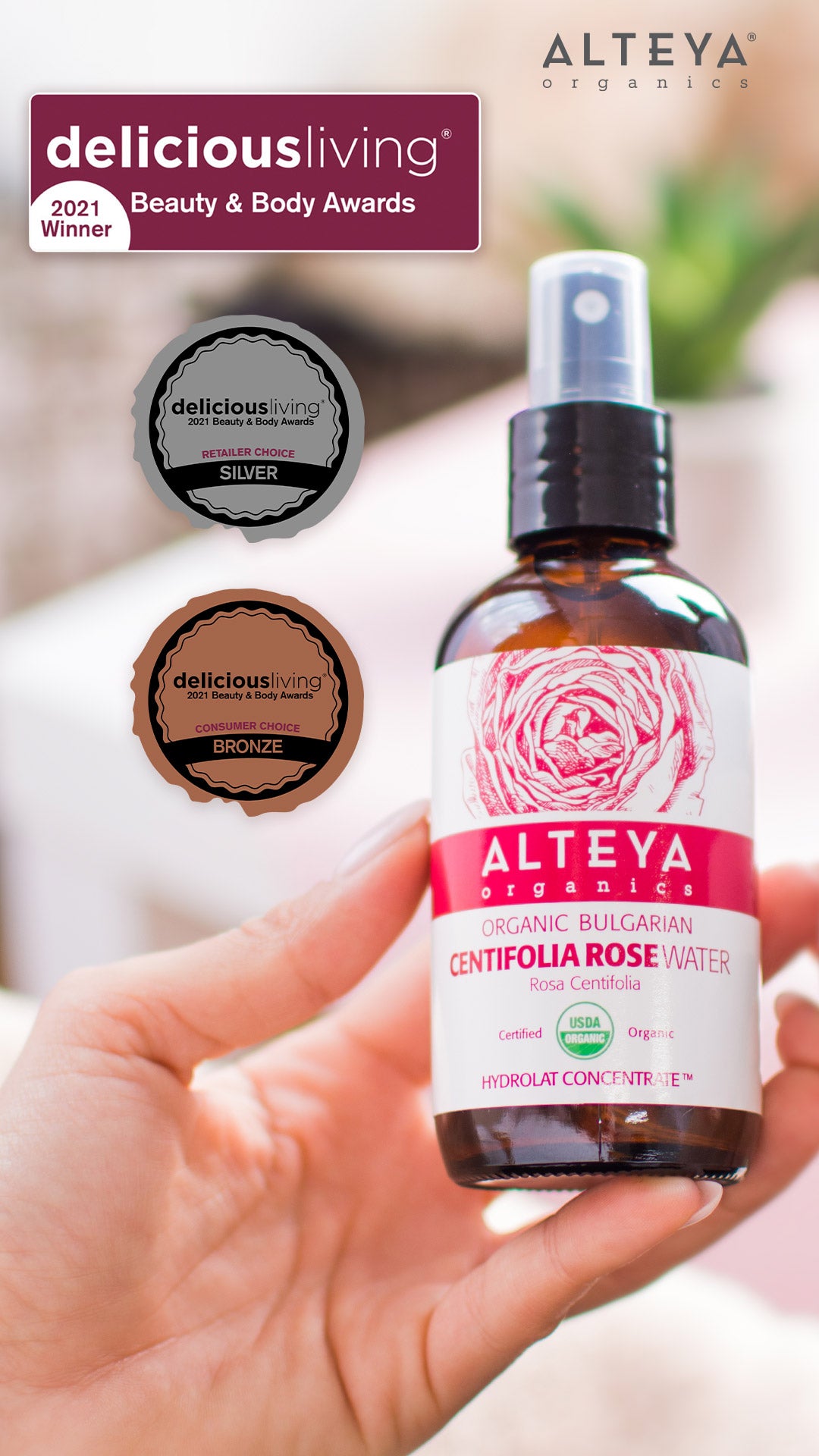 A hand holding a bottle of Alteya's concilia rose facial mist, infused with the essence of Bulgarian Rosa Damascena.