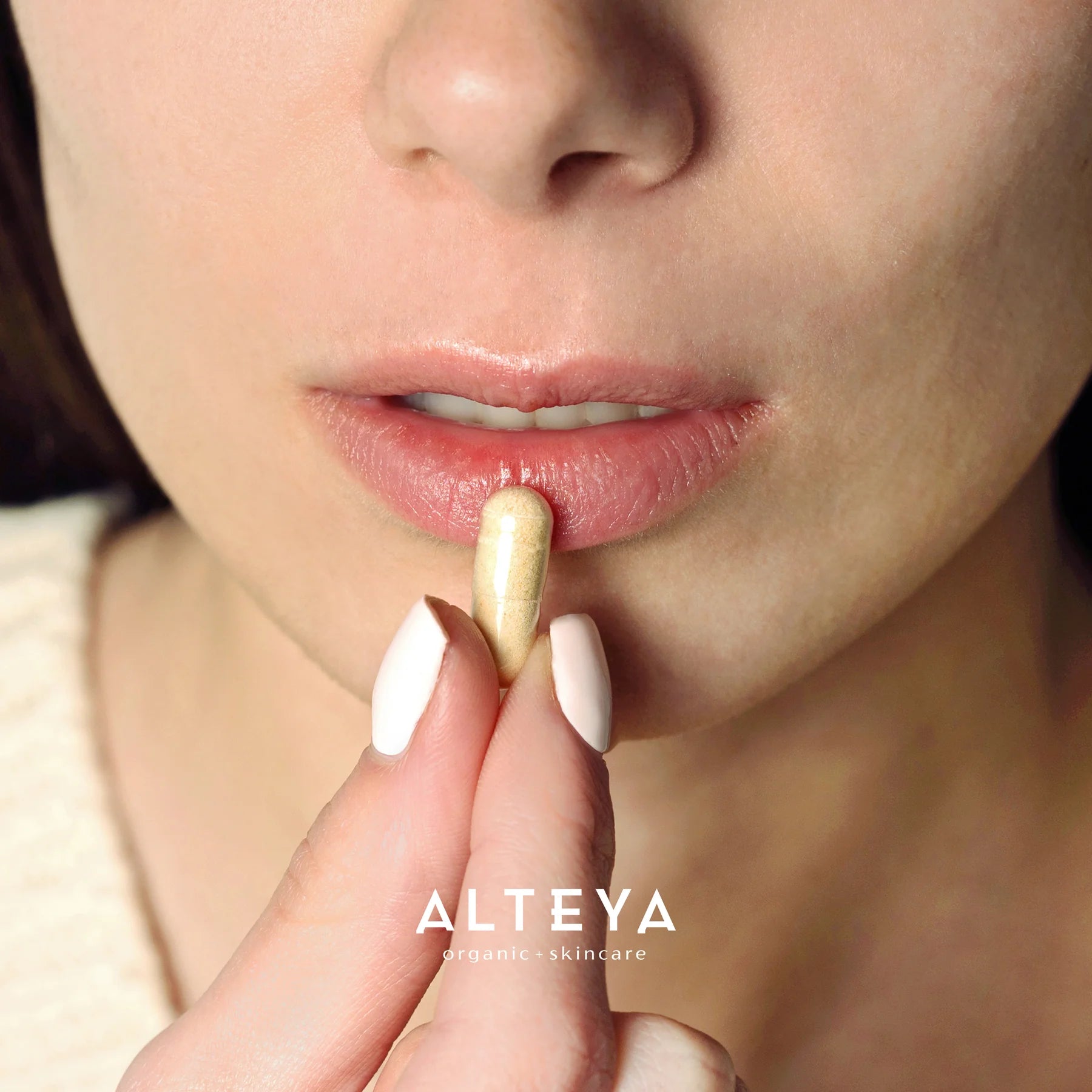 A woman is holding the Rose Beauty Prebiotic and Probiotic - Synbiotic Skin & Metabolism Vegan Organic Supplement in her mouth, promoting gut health and skin appearance.