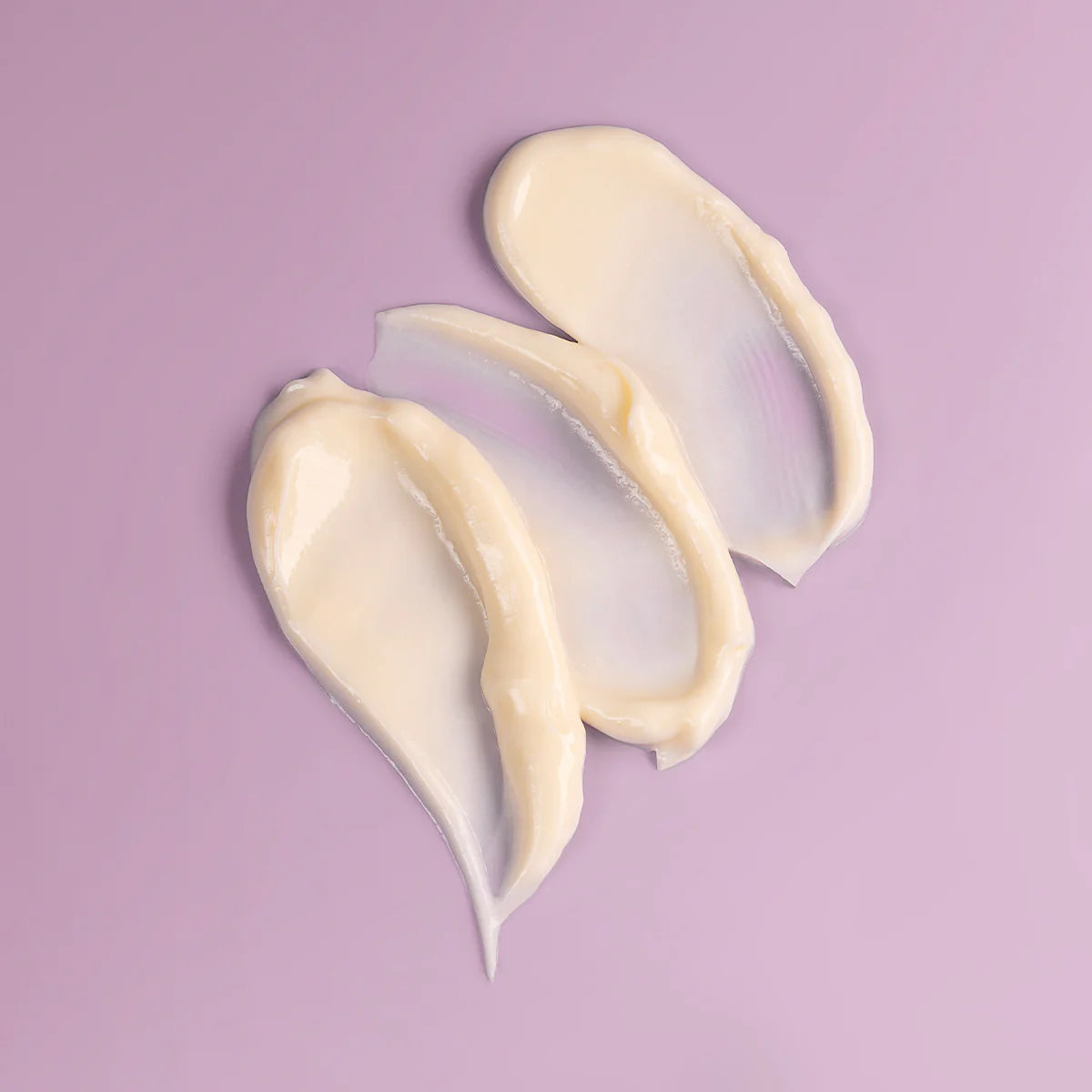 Three pieces of Bio Damascena Rose Otto Night Moisturizer on a purple background.