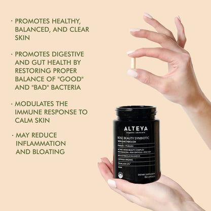 A hand holding a bottle of Rose Beauty Prebiotic and Probiotic - Synbiotic Skin &amp; Metabolism Vegan Organic Supplement, beneficial for gut health and enhancing skin appearance.
