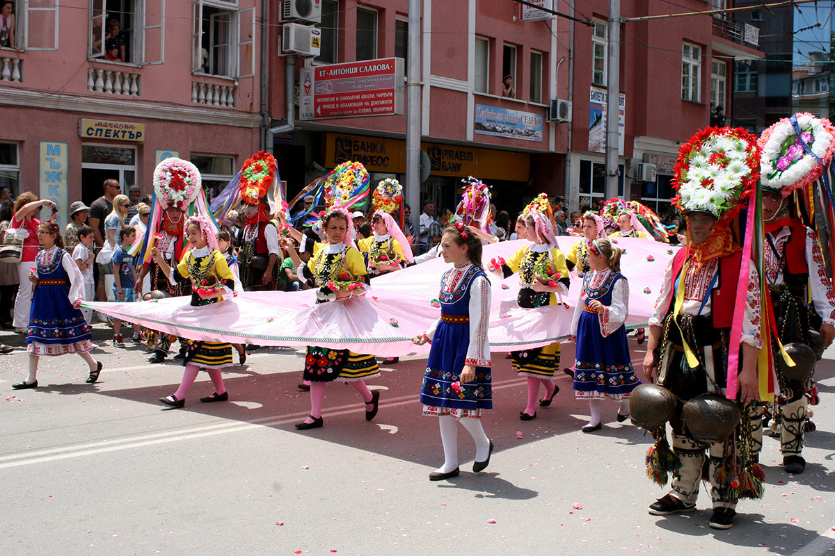 A group of people strolling through vibrant rose fields, captivated by the enchanting fragrance of Bulgarian rose and Rosa damascena.